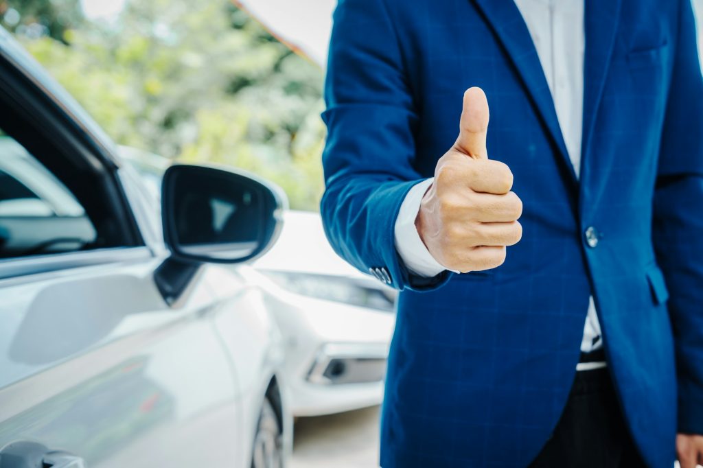 businessman in suit and car auto insurance agent assess car damage, discussing deductible, claims